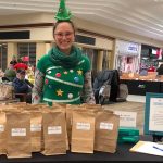 An elf at the children museums table at the winter market